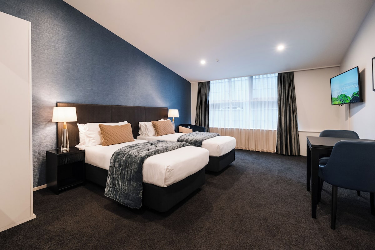2 bedrooms, premium bedding, laptop workspace, blackout drapes