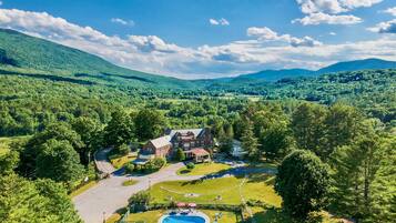 Relax by the spacious pool surrounded by lush surroundings and scenic views.