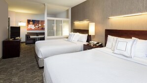 A hotel room with two beds, a TV, a desk, and a sofa. - SpringHill Suites by Marriott Indianapolis Fishers (Fishers)