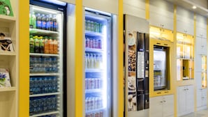 A row of beverage dispensers in a commercial setting. - Premiere Classe Warszawa Centrum (Warsaw)