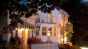 A two-story building with a balcony, a sign for York Harbor Inn, and a well-lit entrance. - York Harbor Inn (York Harbor)