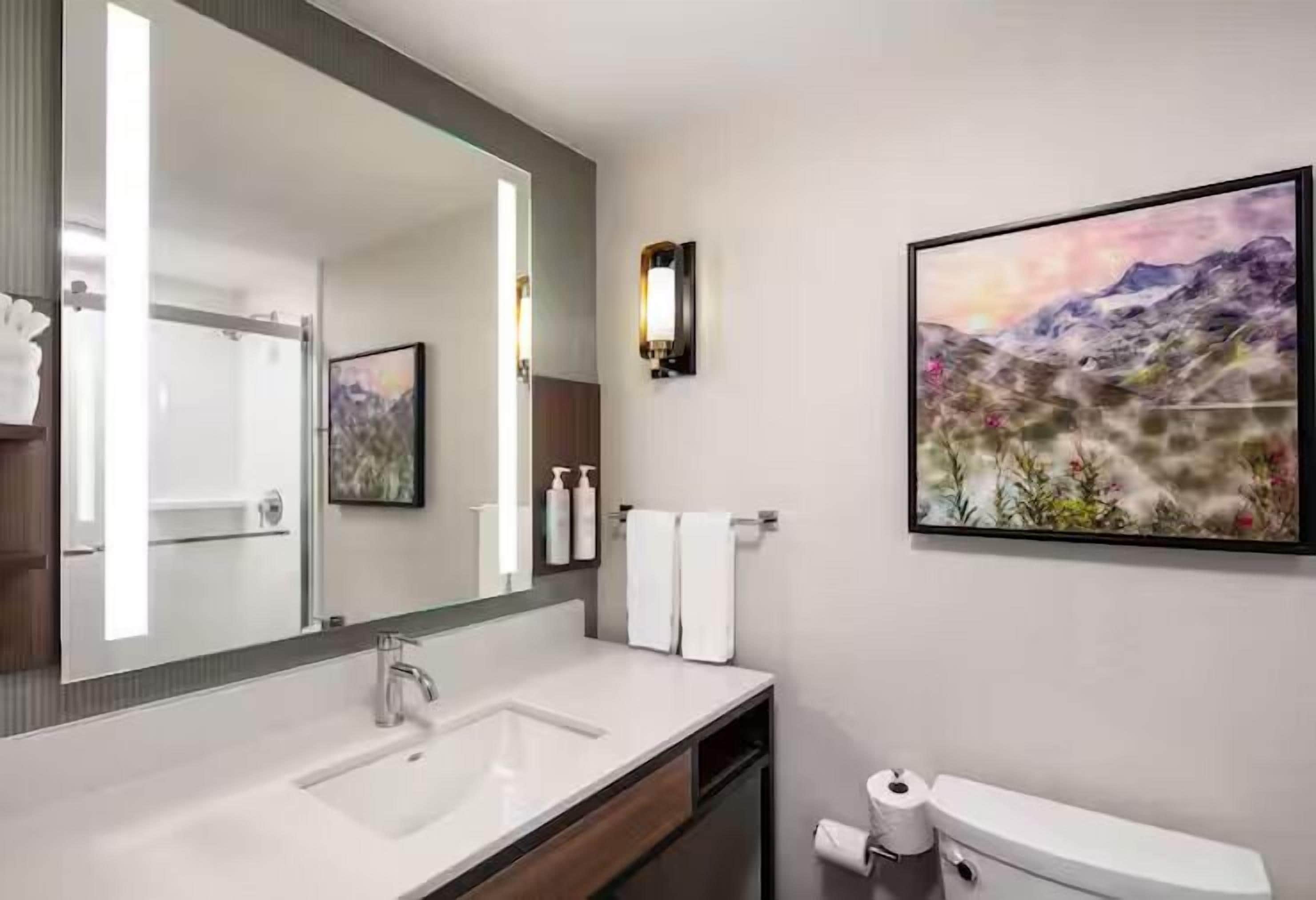 combined shower/bathtub, designer toiletries, hair dryer, bathrobes