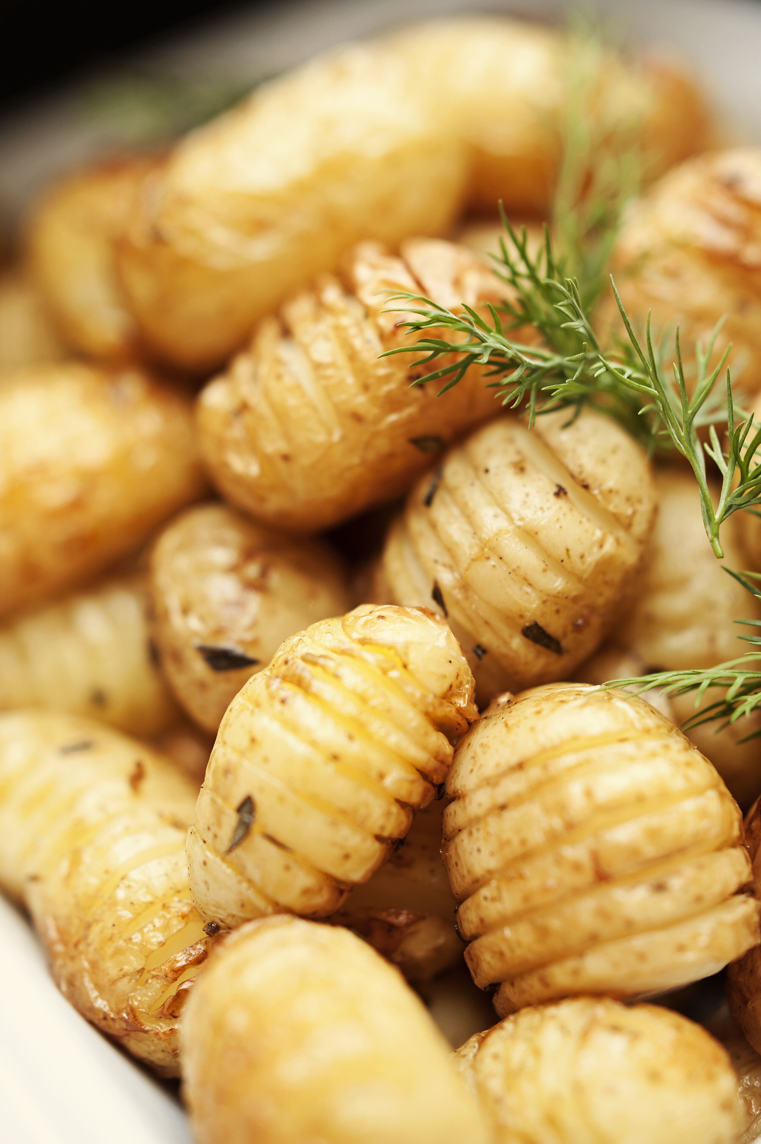 Roasted potatoes garnished with herbs.