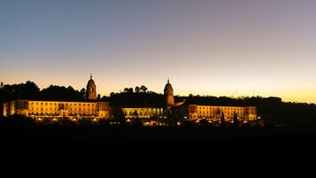 A large, illuminated building with two prominent towers, likely a historic or governmental structure.