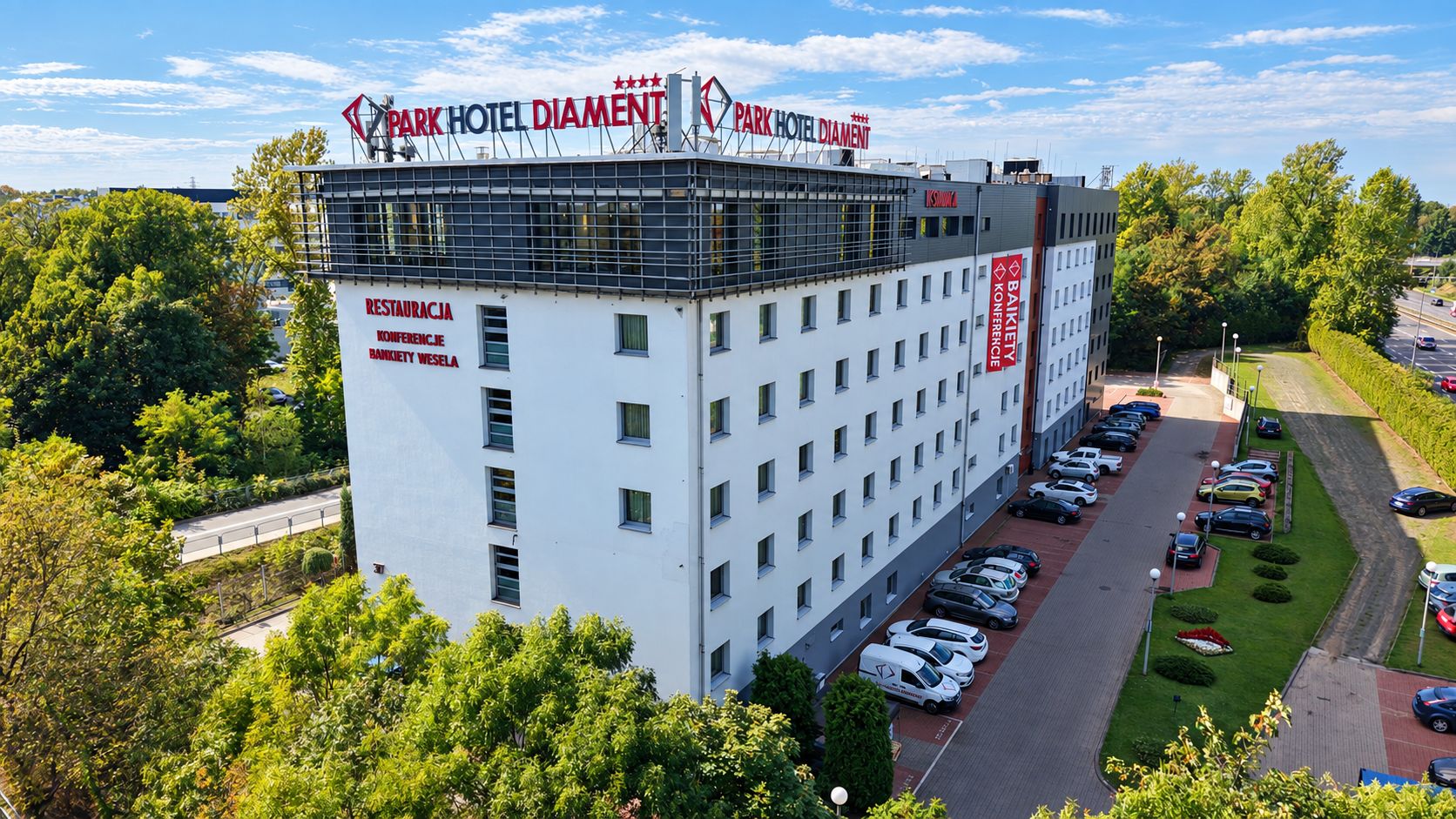 A multi-story hotel with a parking lot and a conference center.