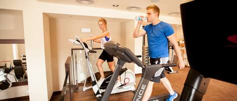 A gym with treadmills and exercise equipment.