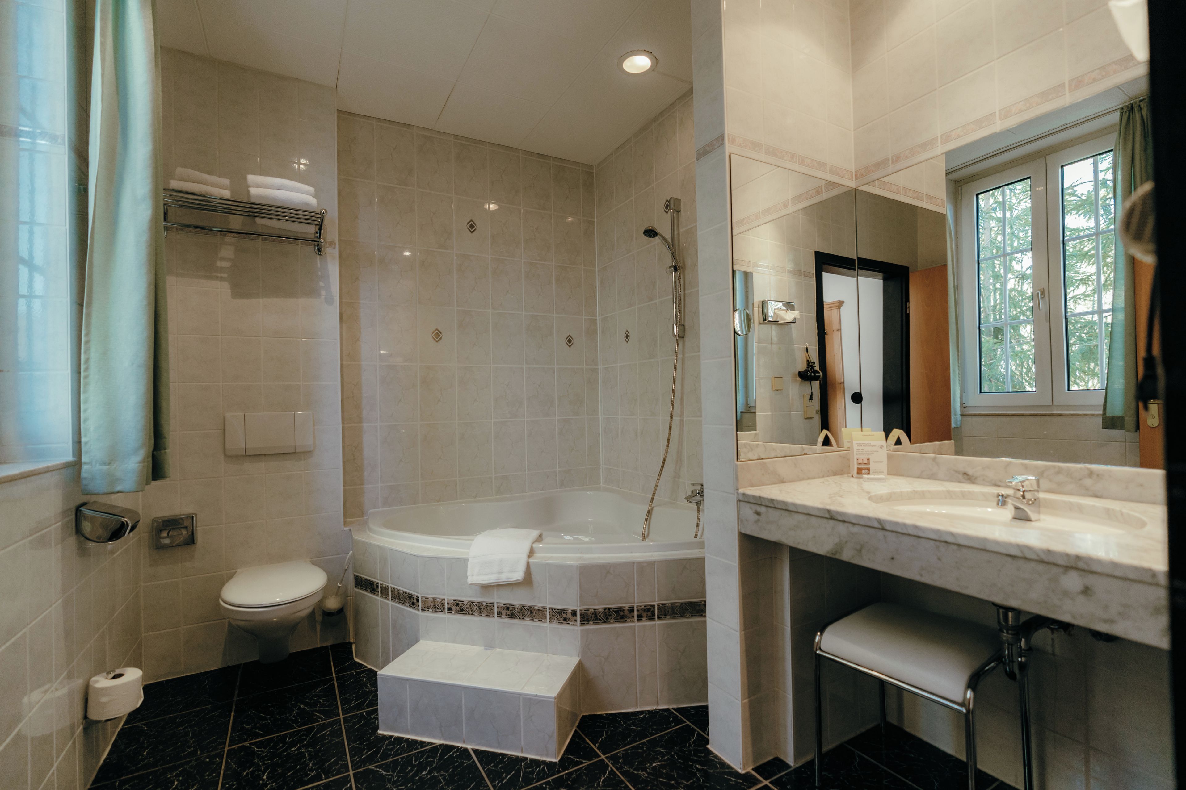 A bathroom with a bathtub, toilet, and sink.