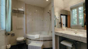 A bathroom with a bathtub, toilet, and sink.