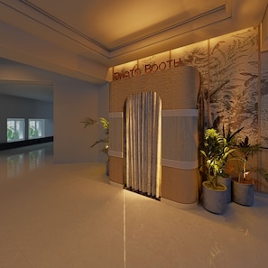 A modern lobby with a reception area labeled "PHOTO BOOTH".