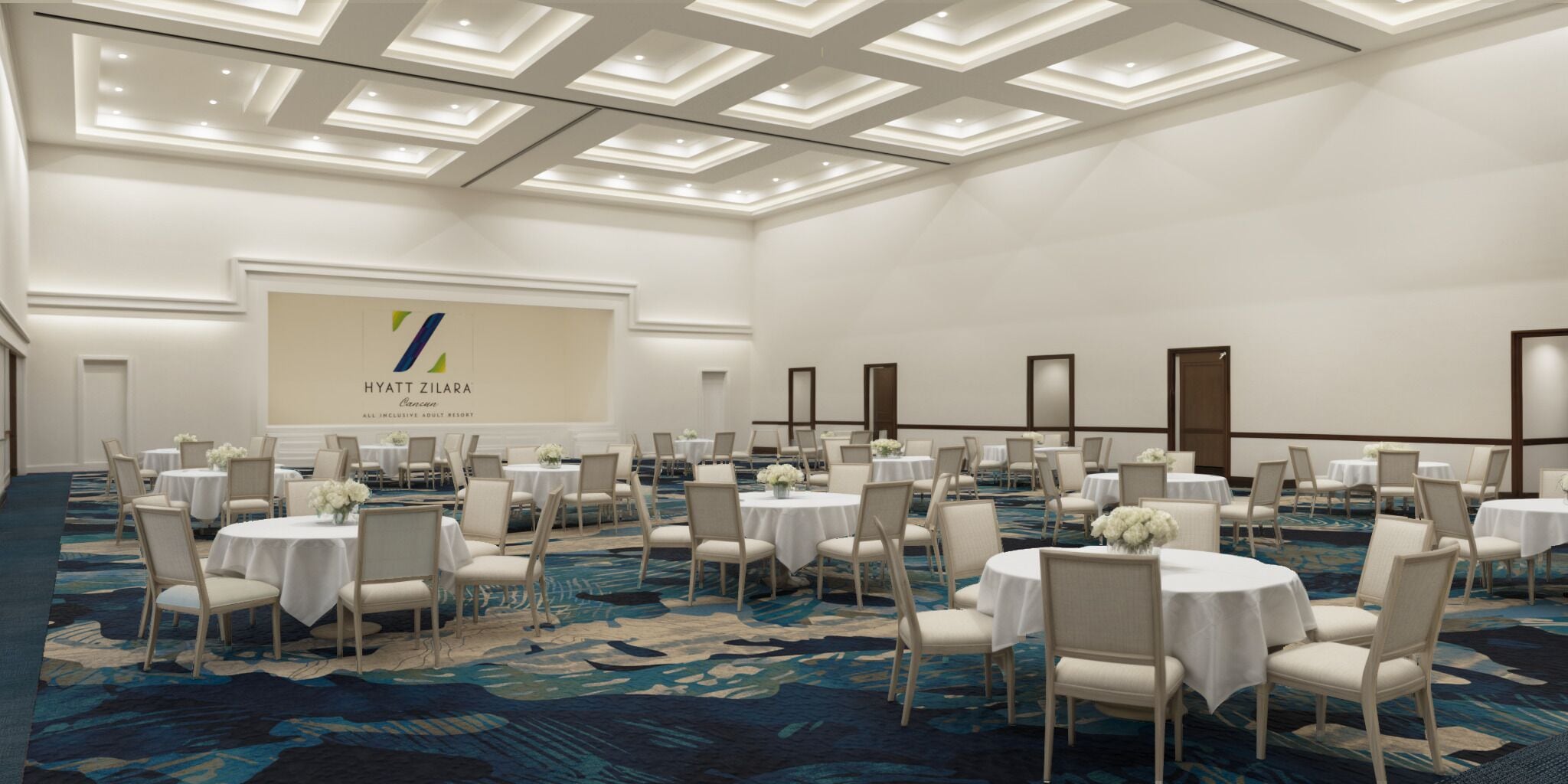 A large, well-lit conference room with round tables and chairs, a carpeted floor, and a large screen displaying the Hyatt Zilara logo.