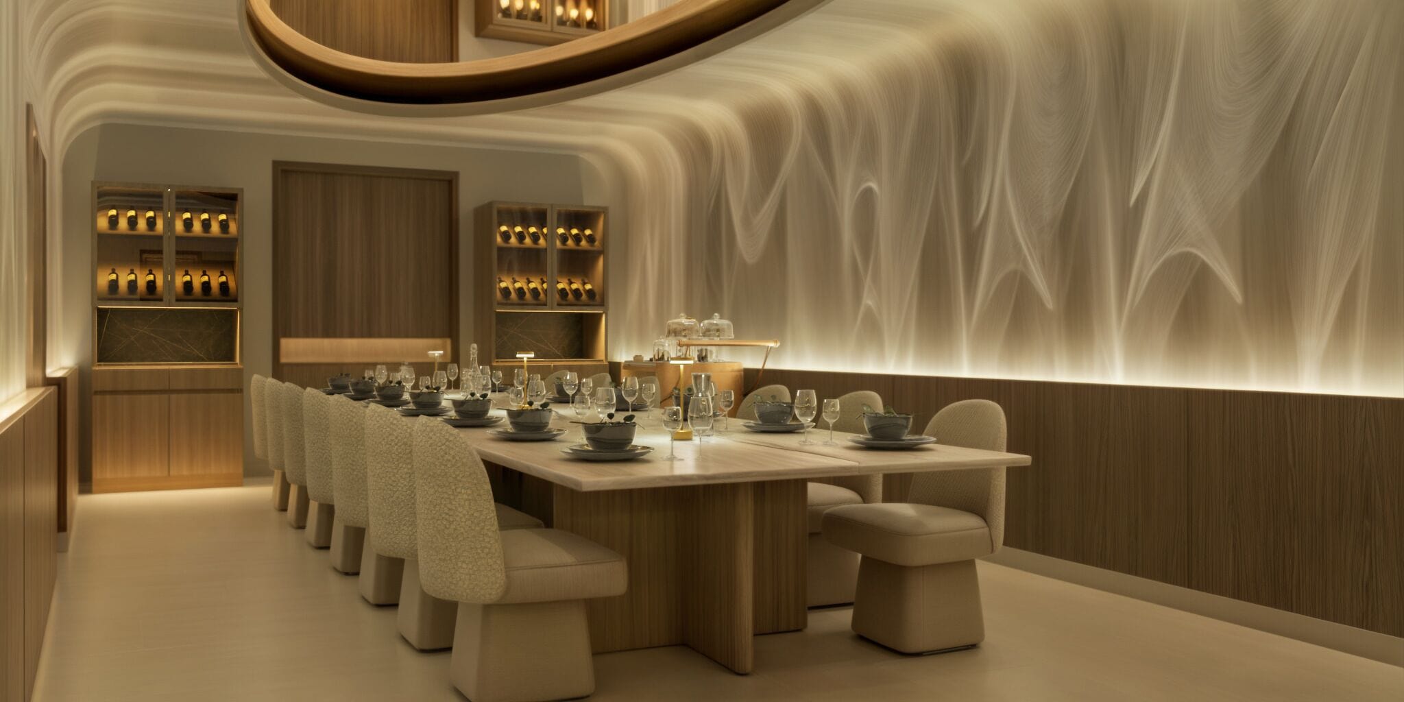 A modern dining area with a long table set for a meal, wooden paneling, and a unique textured wall design.