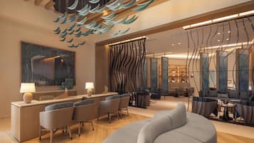 Un moderno vestíbulo de hotel con mostrador de recepción, zona de estar y un gran cuadro abstracto.