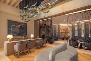 A modern hotel lobby with a reception desk, seating area, and a large abstract painting. - Hyatt Zilara Cancun   - Adults Only - All Inclusive (Cancun)