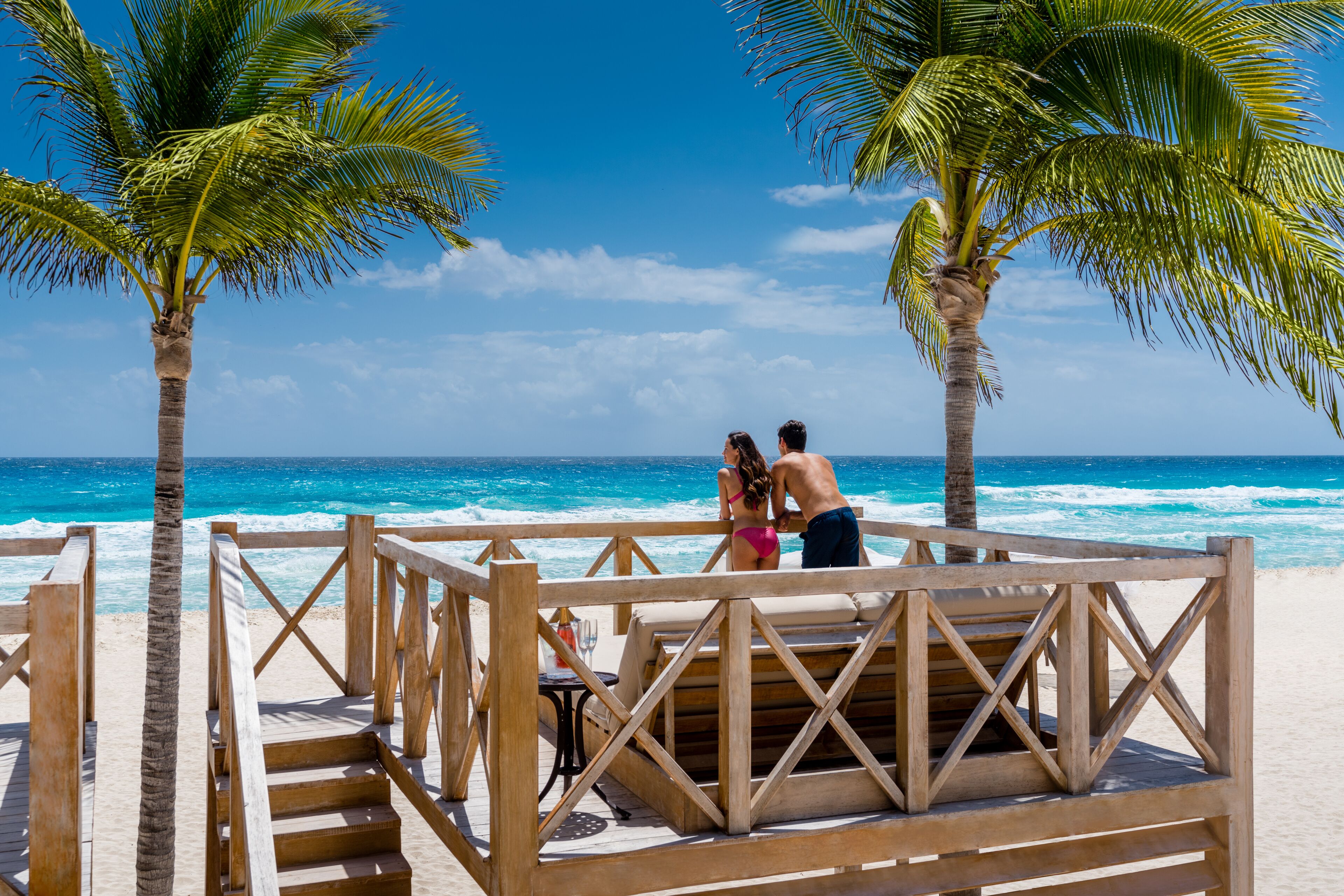 On the beach, white sand, beach cabanas, sun loungers