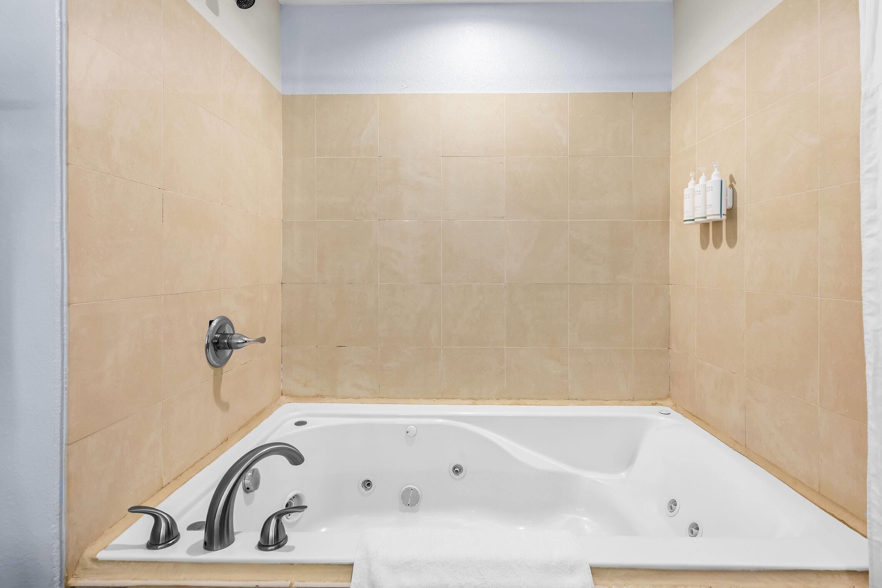 A modern bathroom with a freestanding bathtub, a showerhead, and a towel rack.