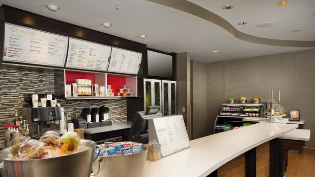 A modern breakfast bar with a menu board, a coffee machine, and a variety of breakfast items displayed. - Courtyard by Marriott San Antonio Lackland (San Antonio)