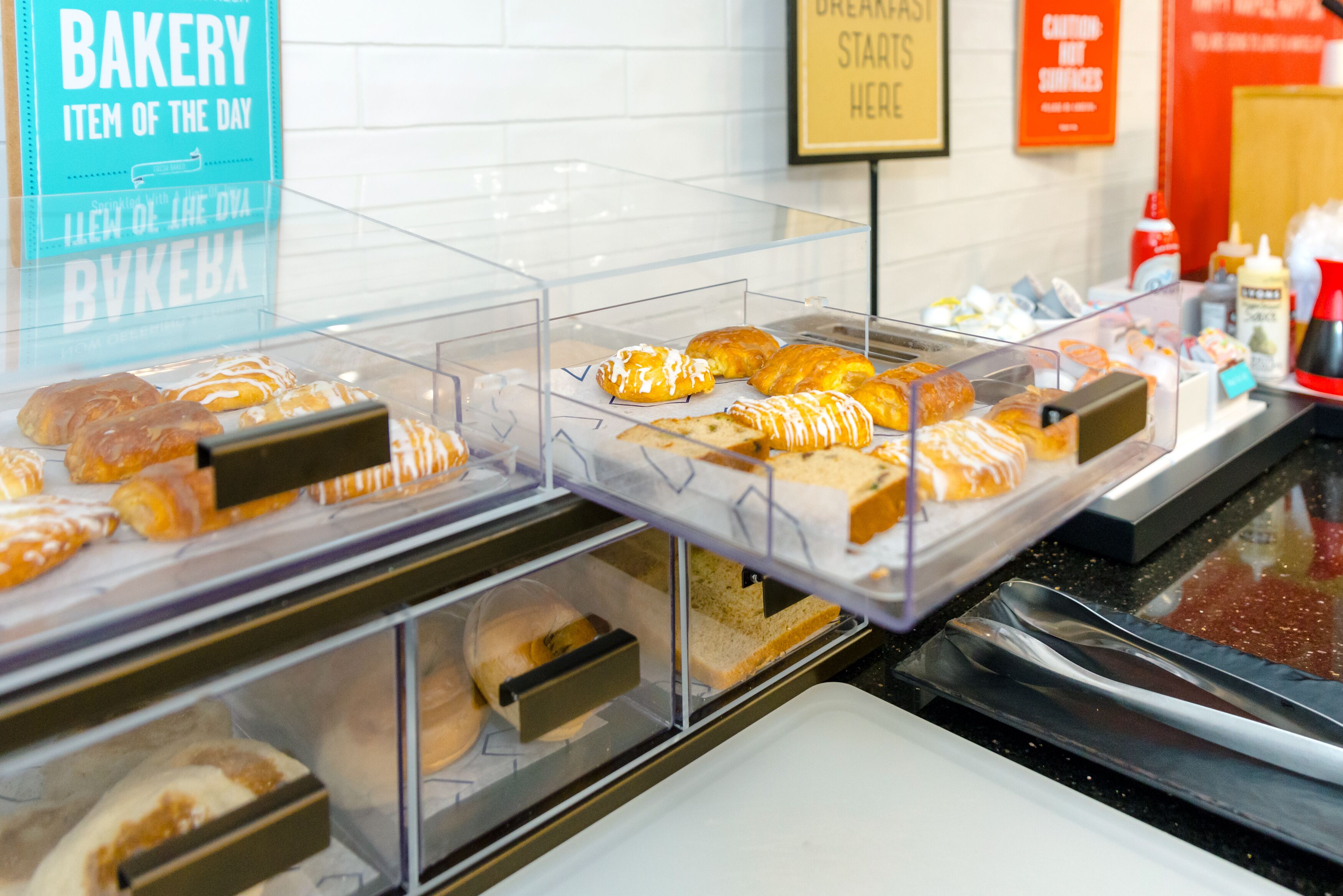 A bakery display case with various baked goods.