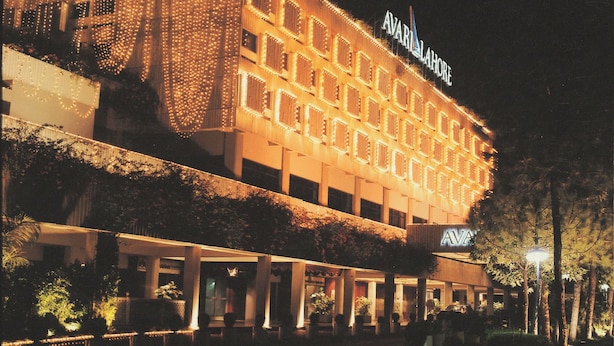 A multi-story hotel with a sign reading "Ava Lahore" and "Ava." The building features a modern architectural design with a flat roof and a series of windows. - Avari Lahore (Lahore)
