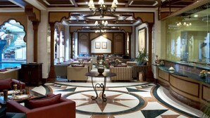 A luxurious lobby with a grand chandelier, a pool view, and a bar area. - Avari Lahore (Lahore)