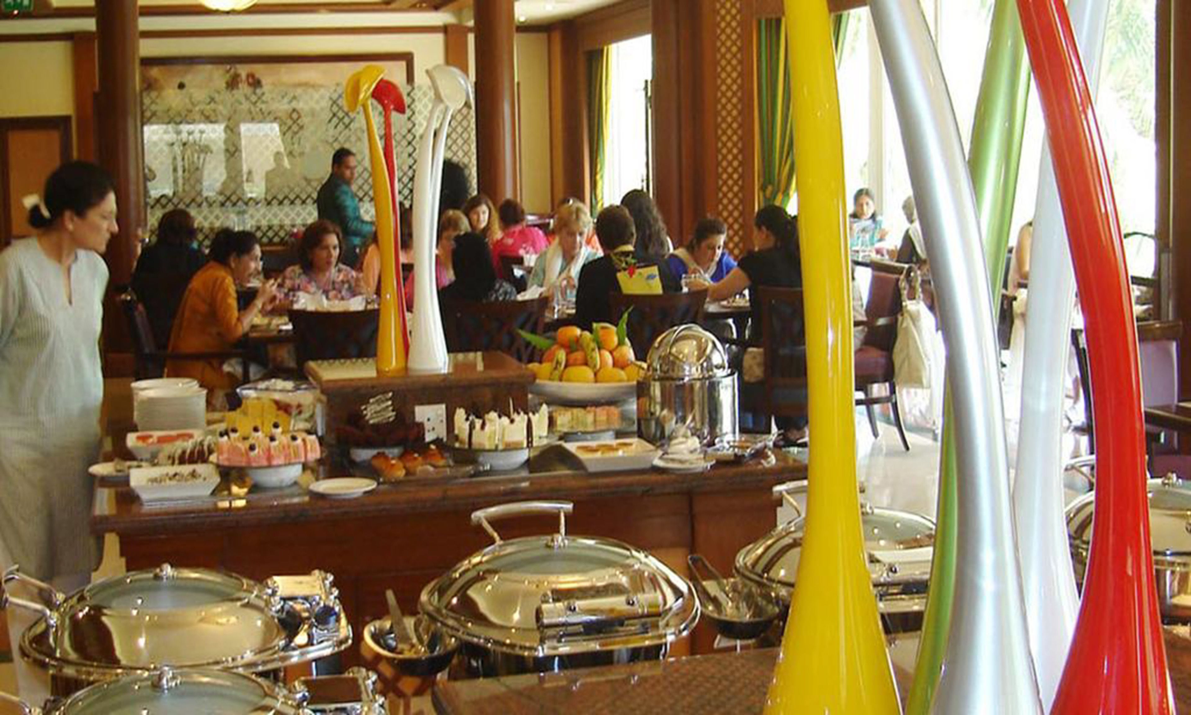 A buffet area with various food items and serving utensils.