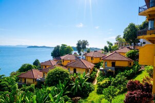 Un barrio residencial costero con casas amarillas, cielo despejado y vista al mar.