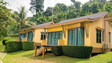 A row of yellow buildings with large windows and a covered walkway.