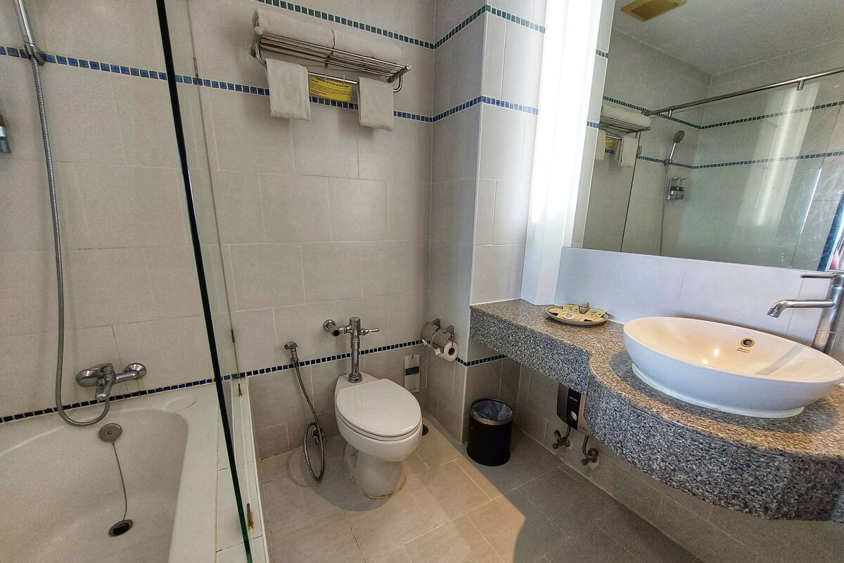 A bathroom with a bathtub, a toilet, a sink, and a shower.