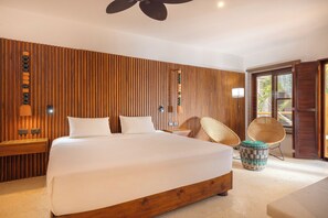 A modern bedroom with a large bed, wooden paneling, a ceiling fan, and a view of the outdoors. - Villas HM Paraiso del Mar (Isla Holbox)
