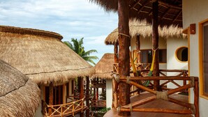 A thatched-roof structure with wooden railings and a wooden platform.