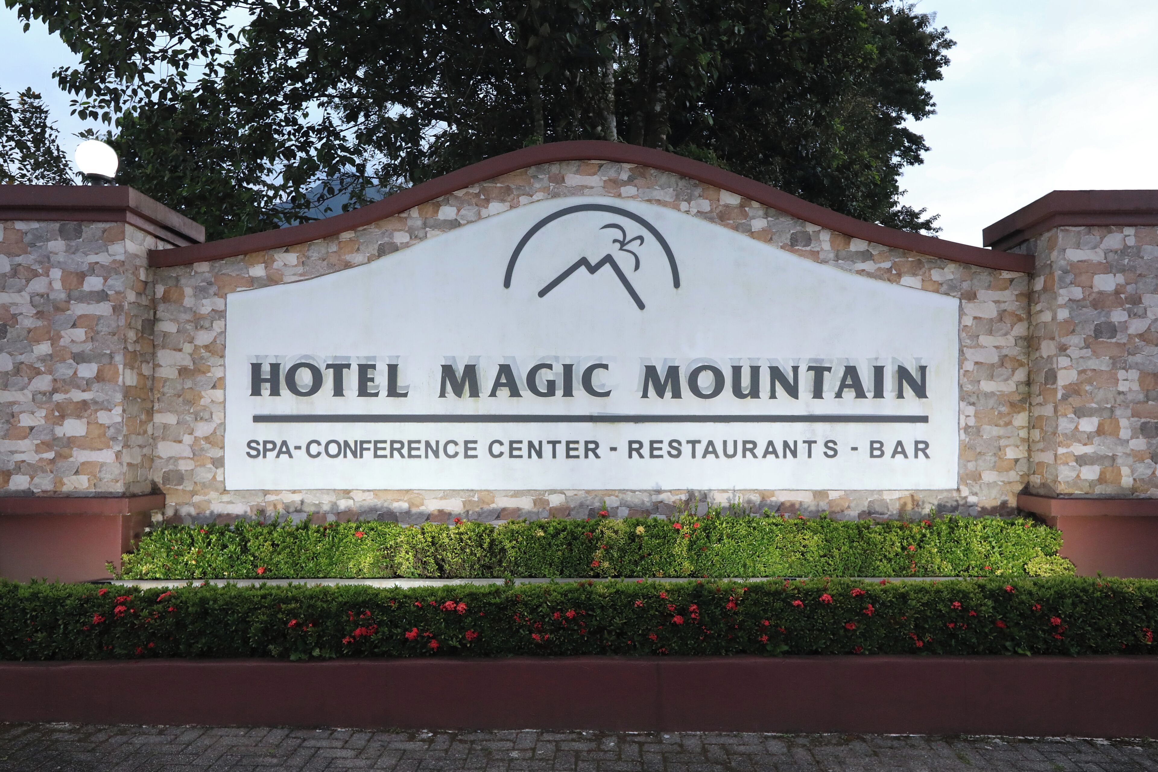 A sign for Hotel Magic Mountain with a spa-conference center, restaurants, and bar.