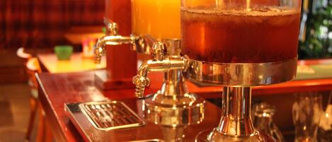 A bar area with a tap and a glass of amber-colored beverage.