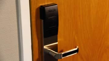 A modern door with a built-in electronic lock and a keyhole.