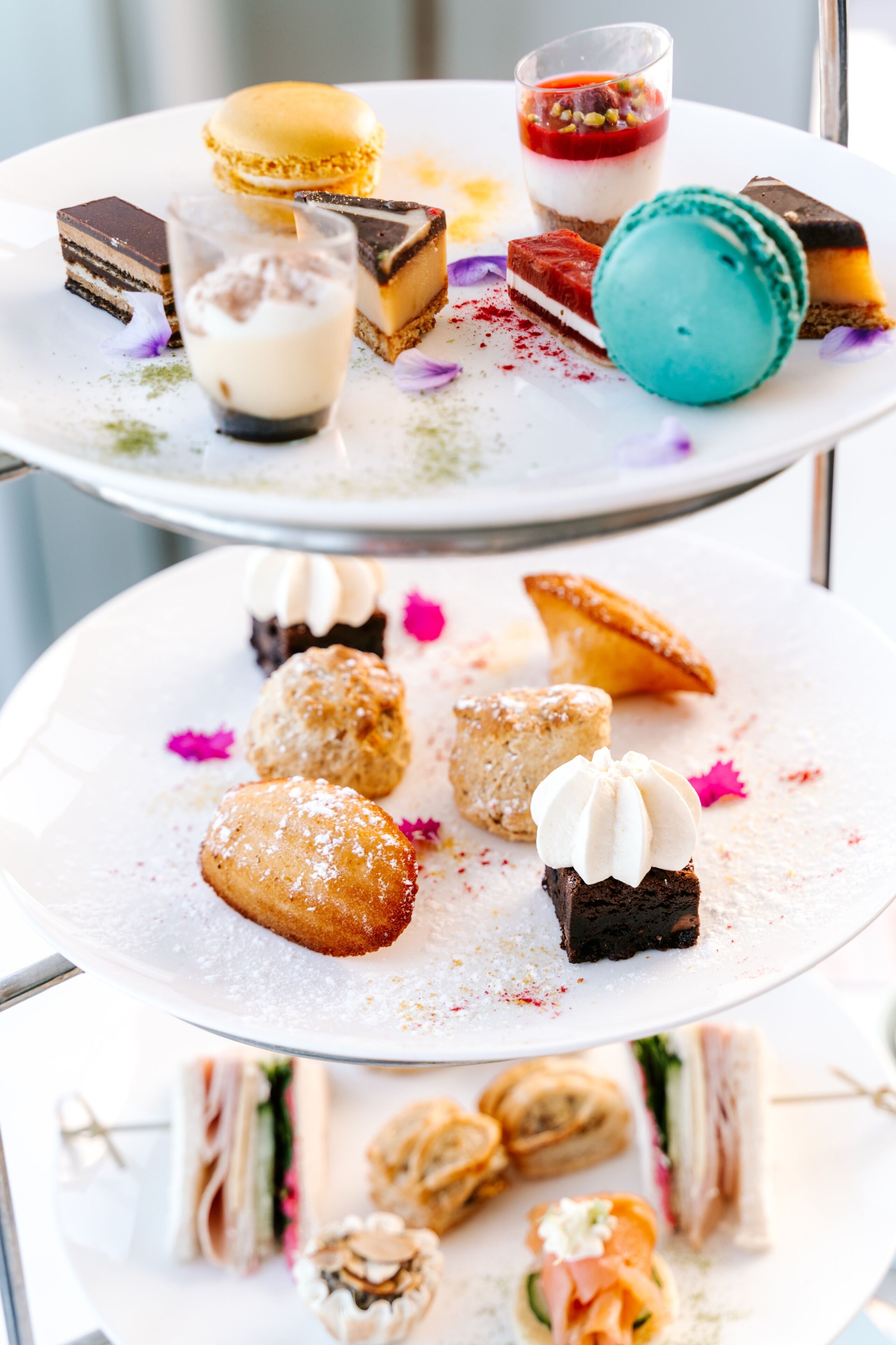 A multi-tiered dessert display with various pastries and desserts.