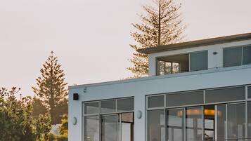 A modern building with large windows and a balcony.