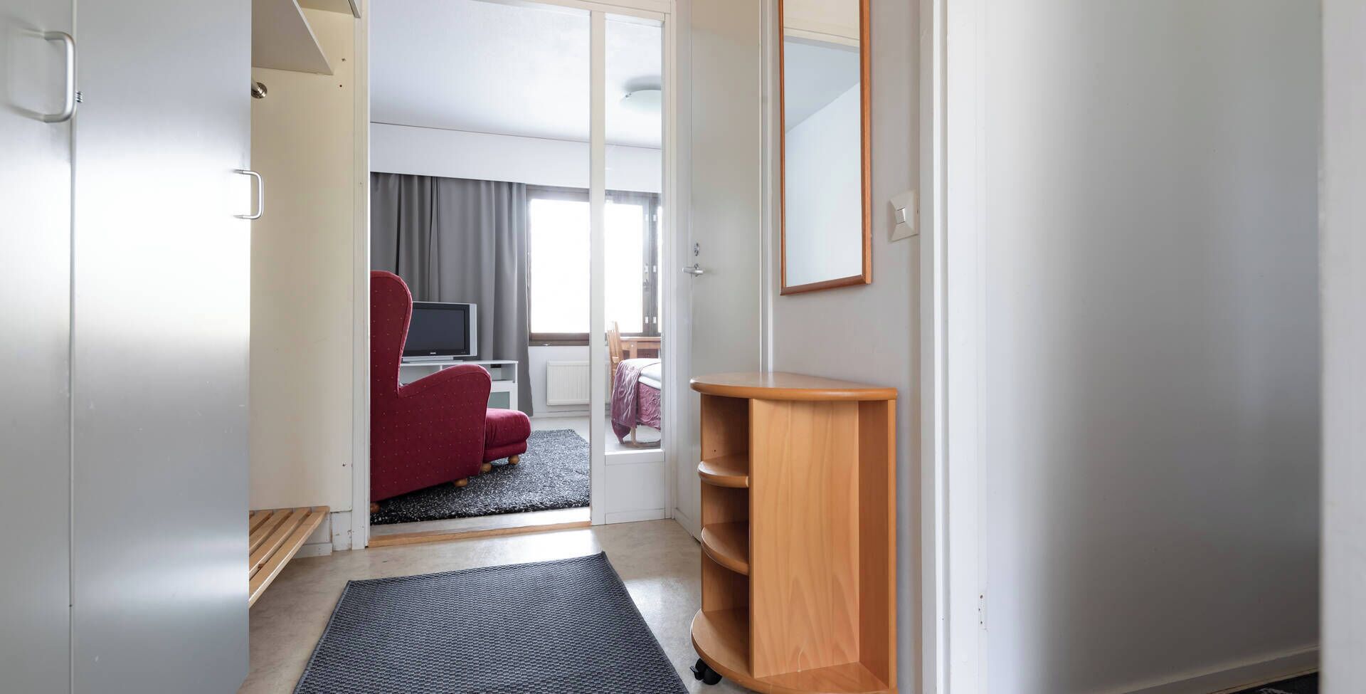 economy studio apartment | desk, bed sheets