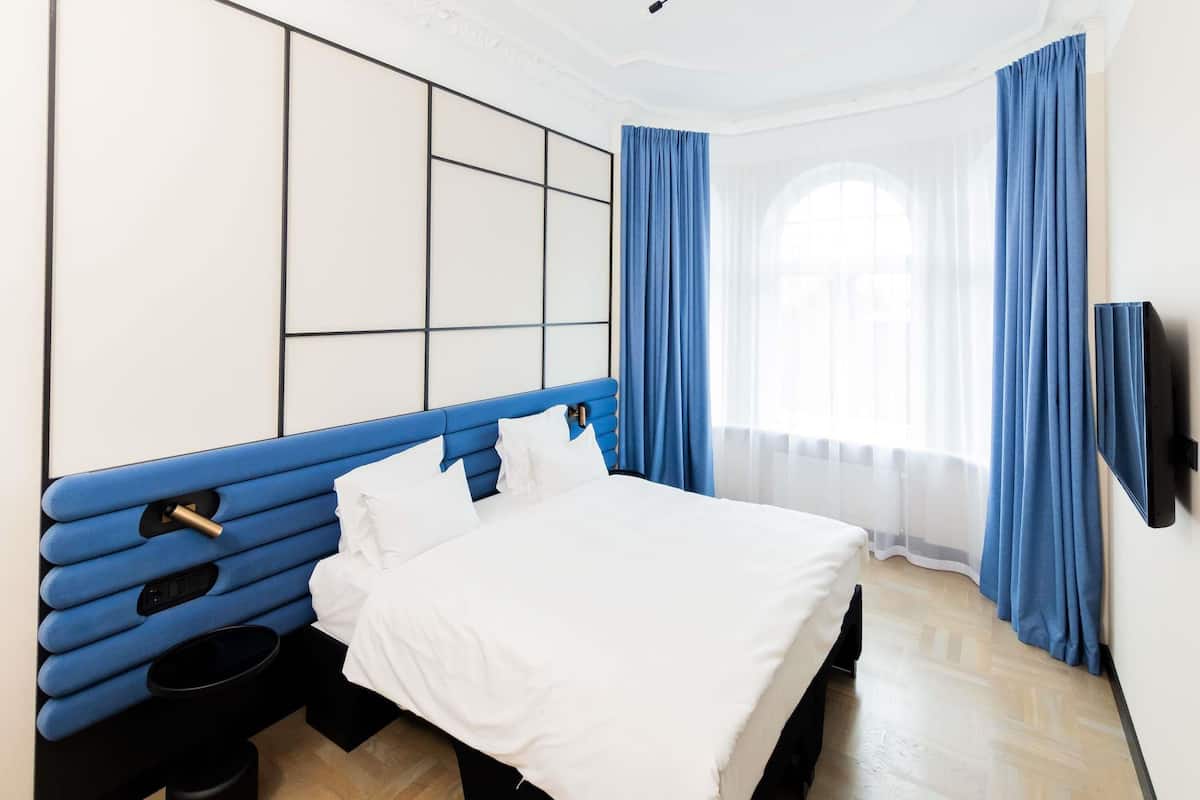 Ropa de cama hipoalergénica y caja de seguridad en la habitación