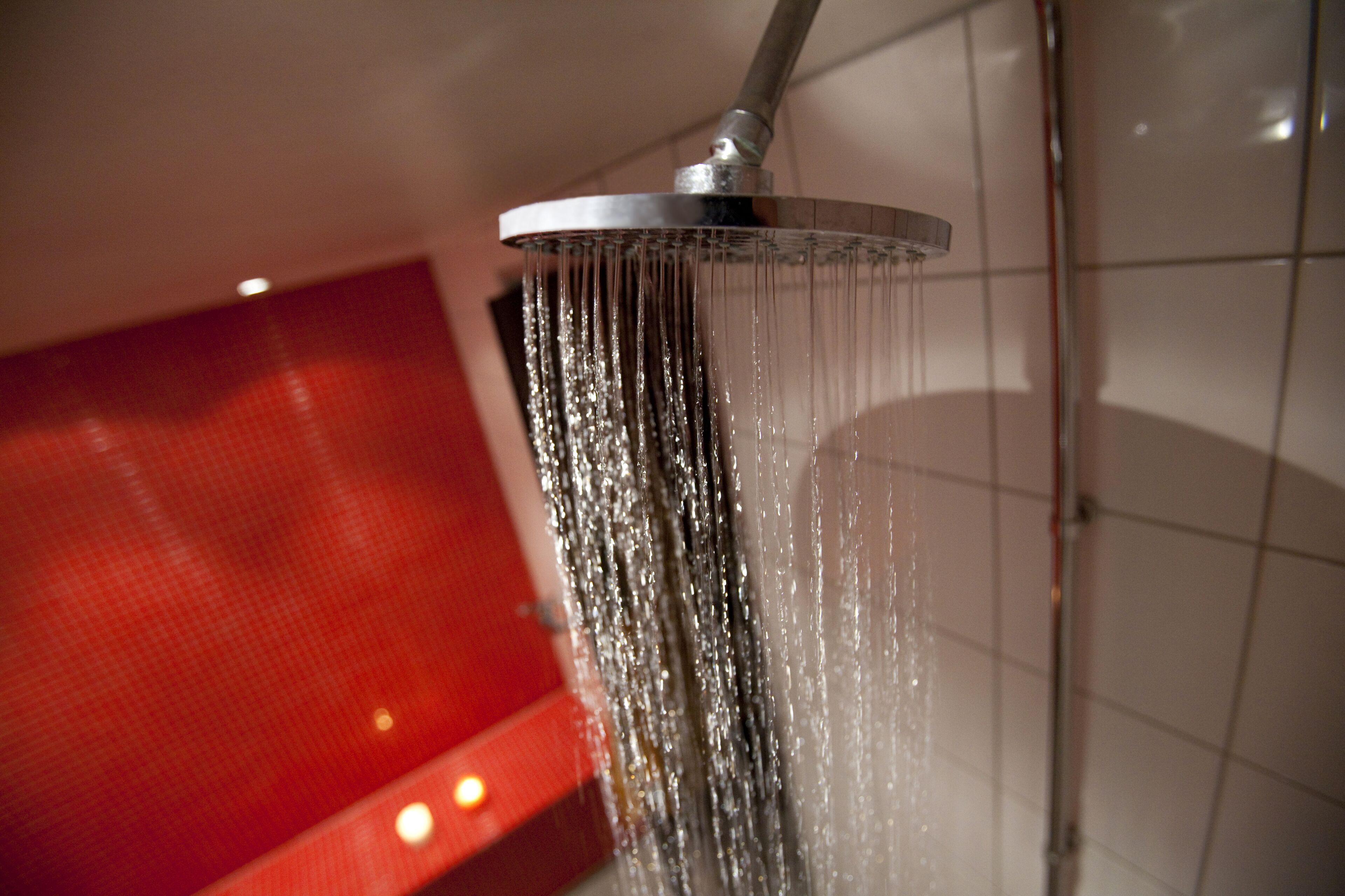 A showerhead with water running.