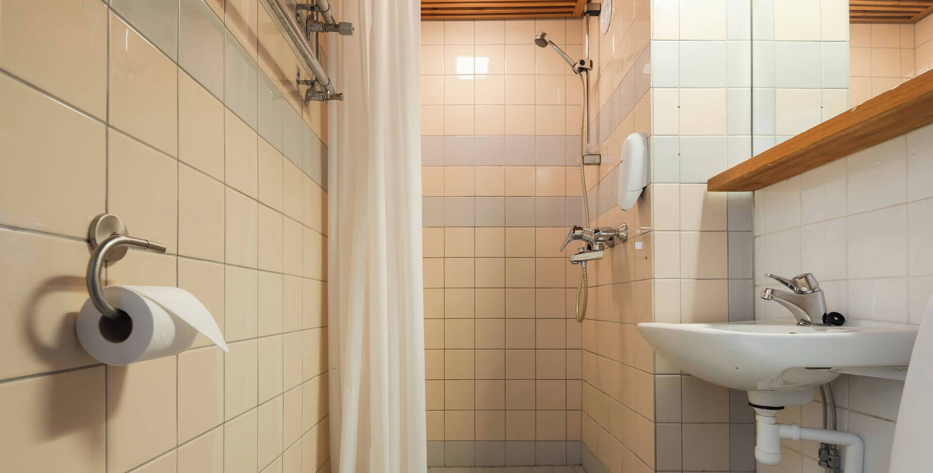 A bathroom with a toilet, a sink, and a shower.