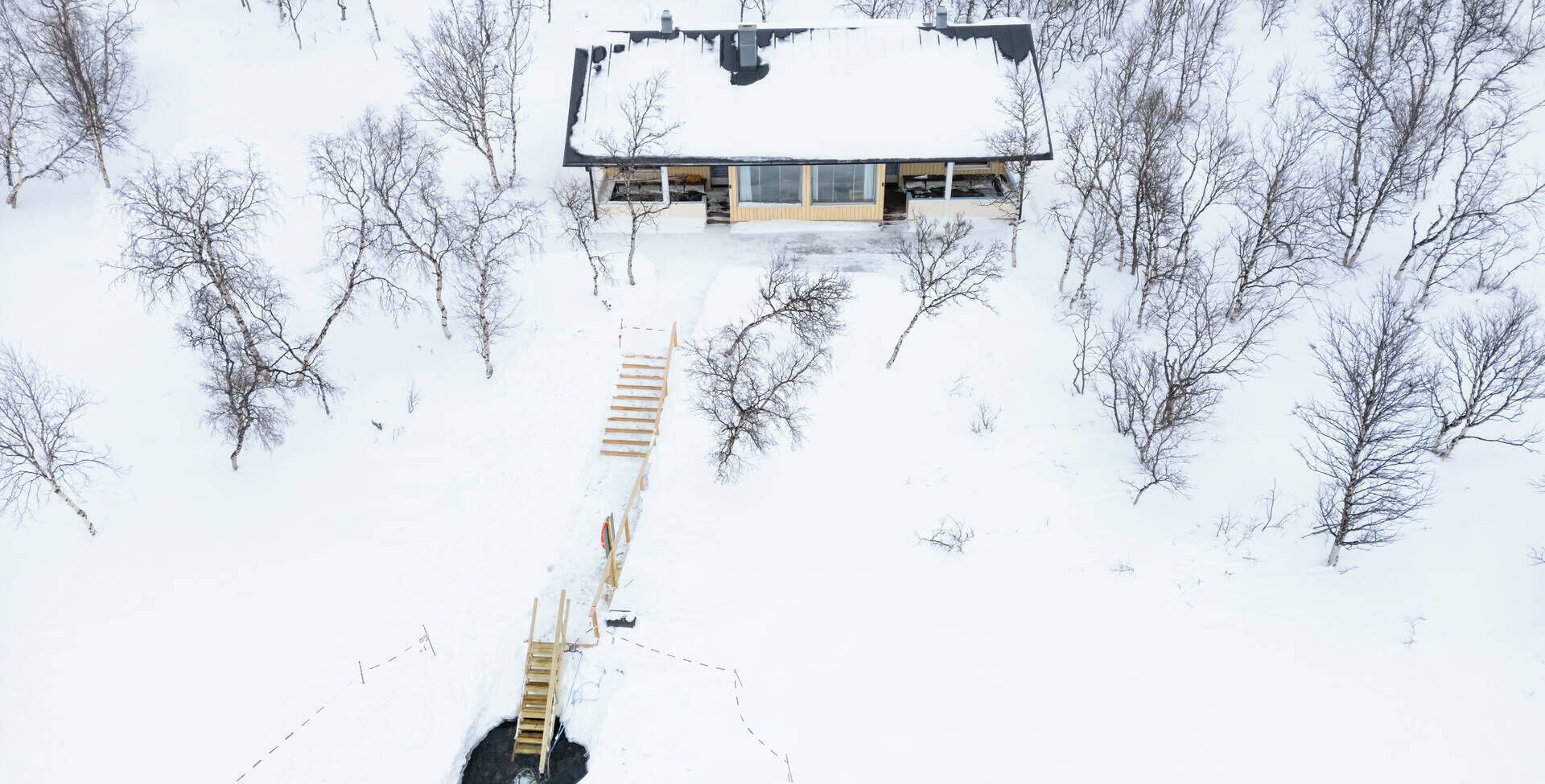 A house surrounded by snow-covered trees.