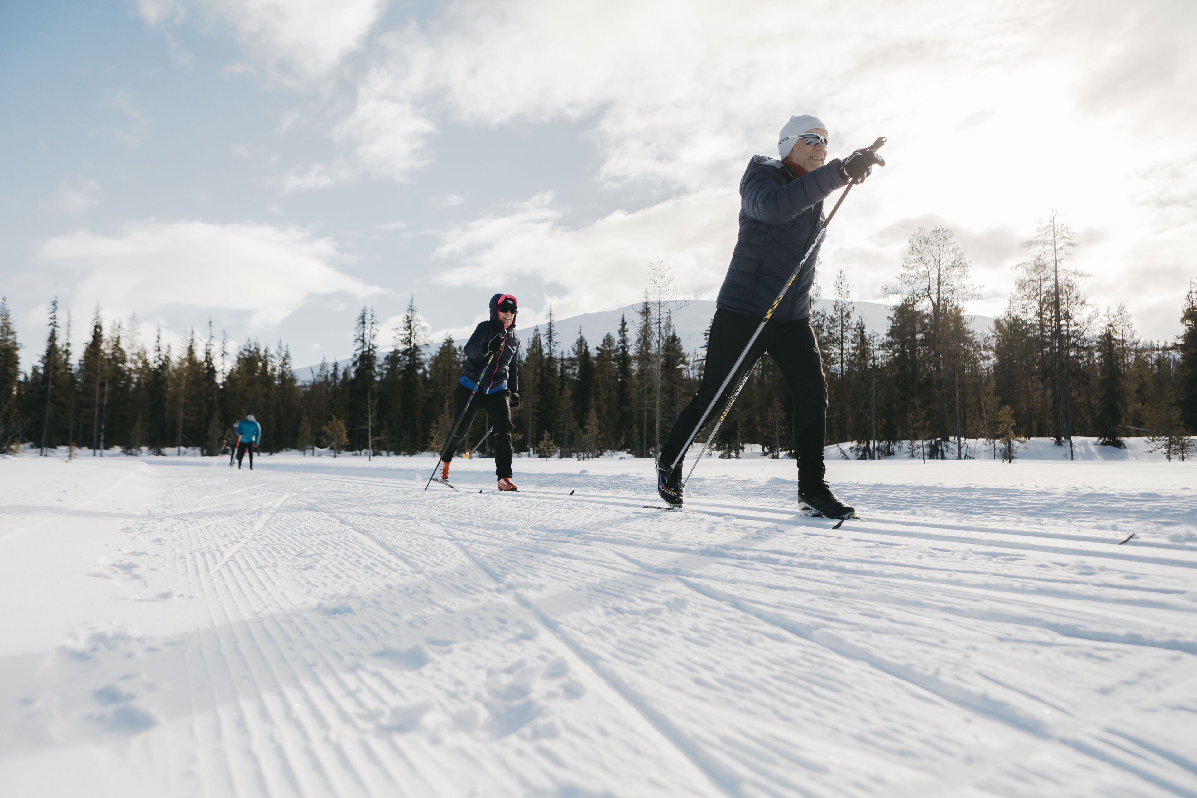 A snowy landscape with skiers.