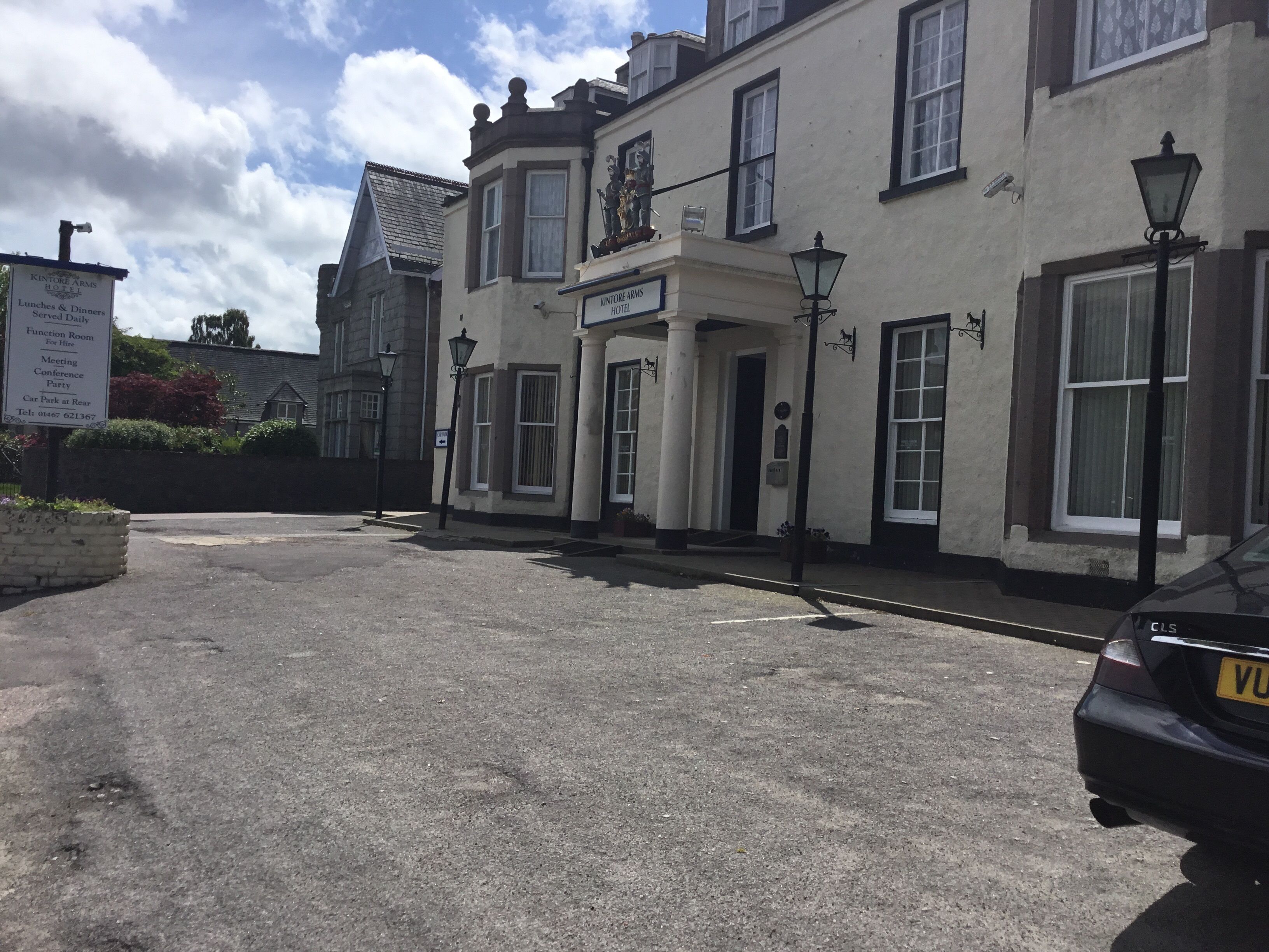 A building with a sign for 'Kintore Arms Hotel' indicating it offers daily lunches and dinners, a function room, and a meeting conference party.