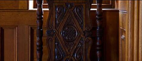 A wooden chair with intricate carvings.