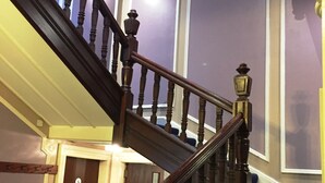 Una escalera de madera con barandilla que lleva a una plataforma.