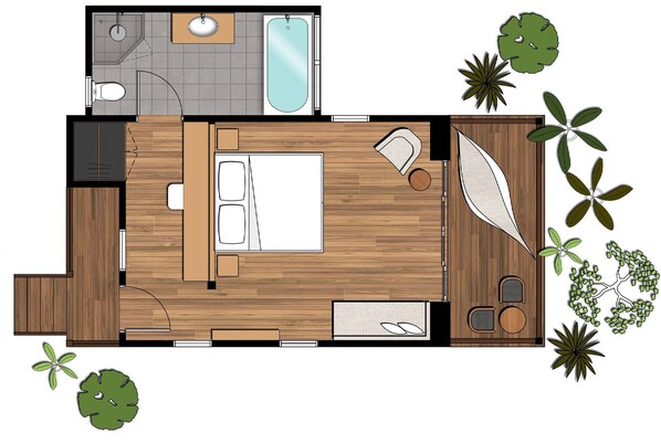 Un dormitorio con una cama grande, una mesita de noche y una ventana. Incluye un baño con inodoro, lavamanos y ducha. La habitación tiene piso de madera y un pequeño balcón con plantas.