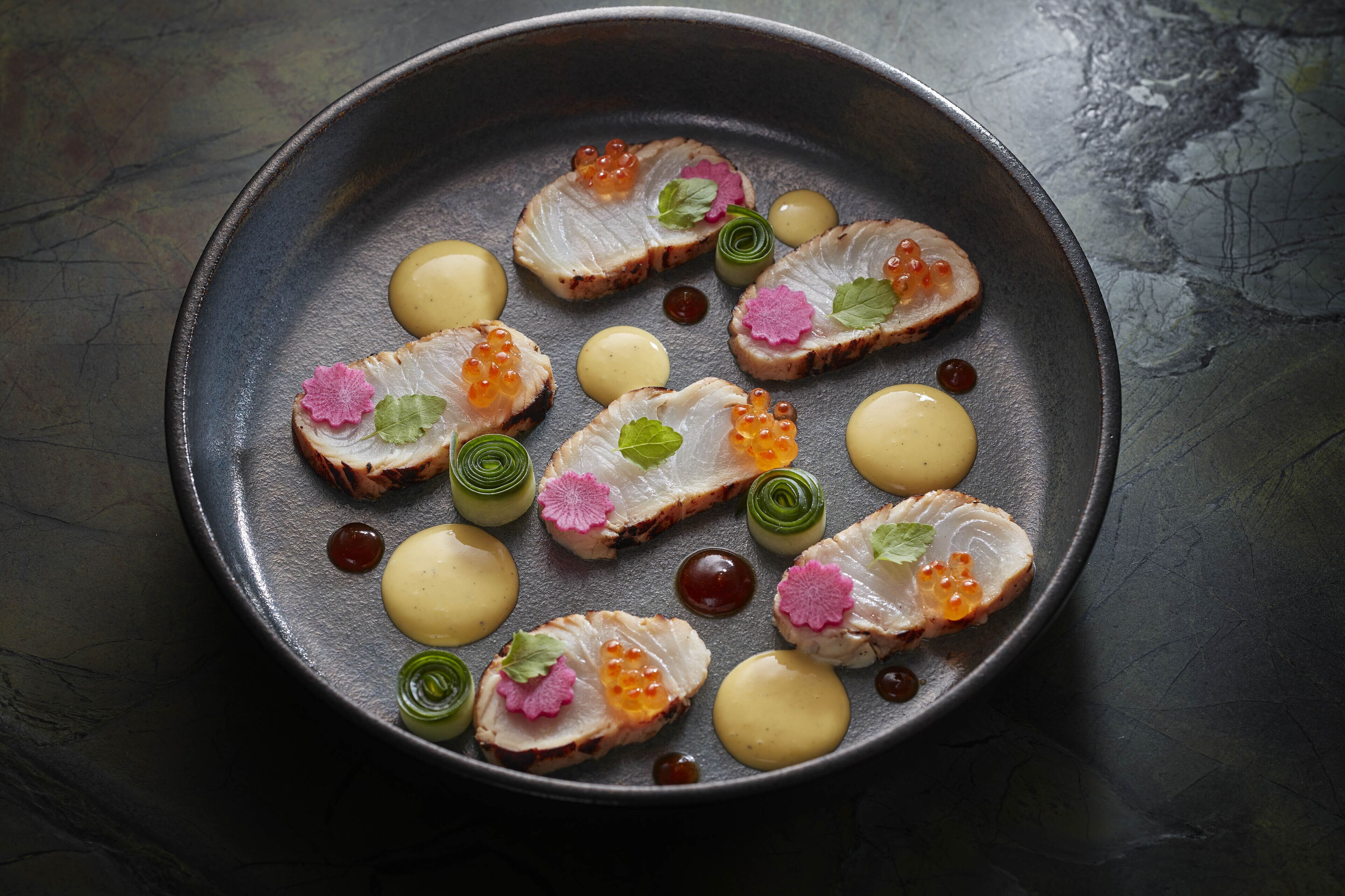 A plate of food with various garnishes and sauces.