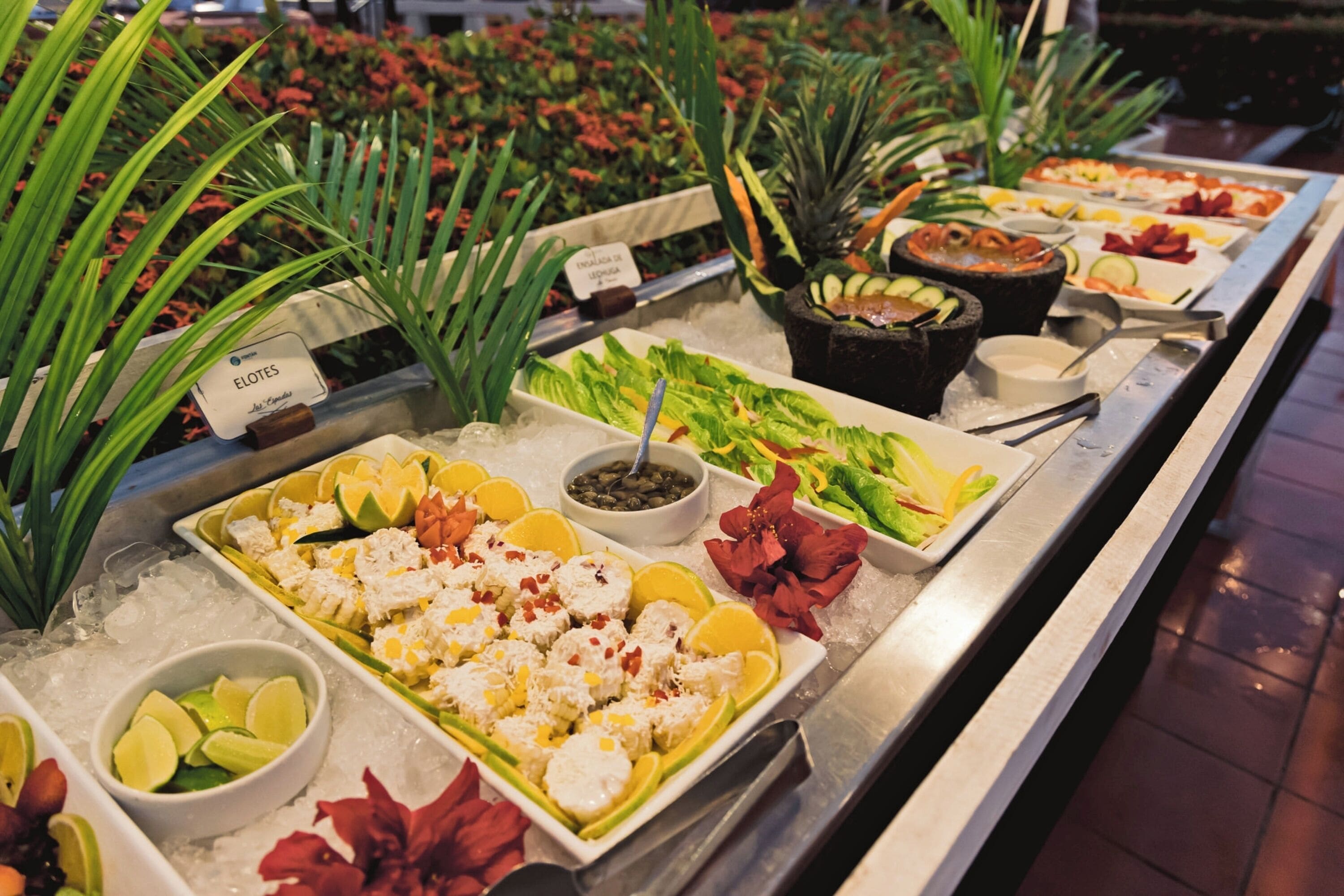 A buffet with various food items and garnishes.
