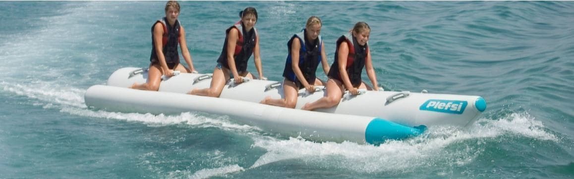 A group of people on a watercraft with the brand 'Pielfsi' visible.