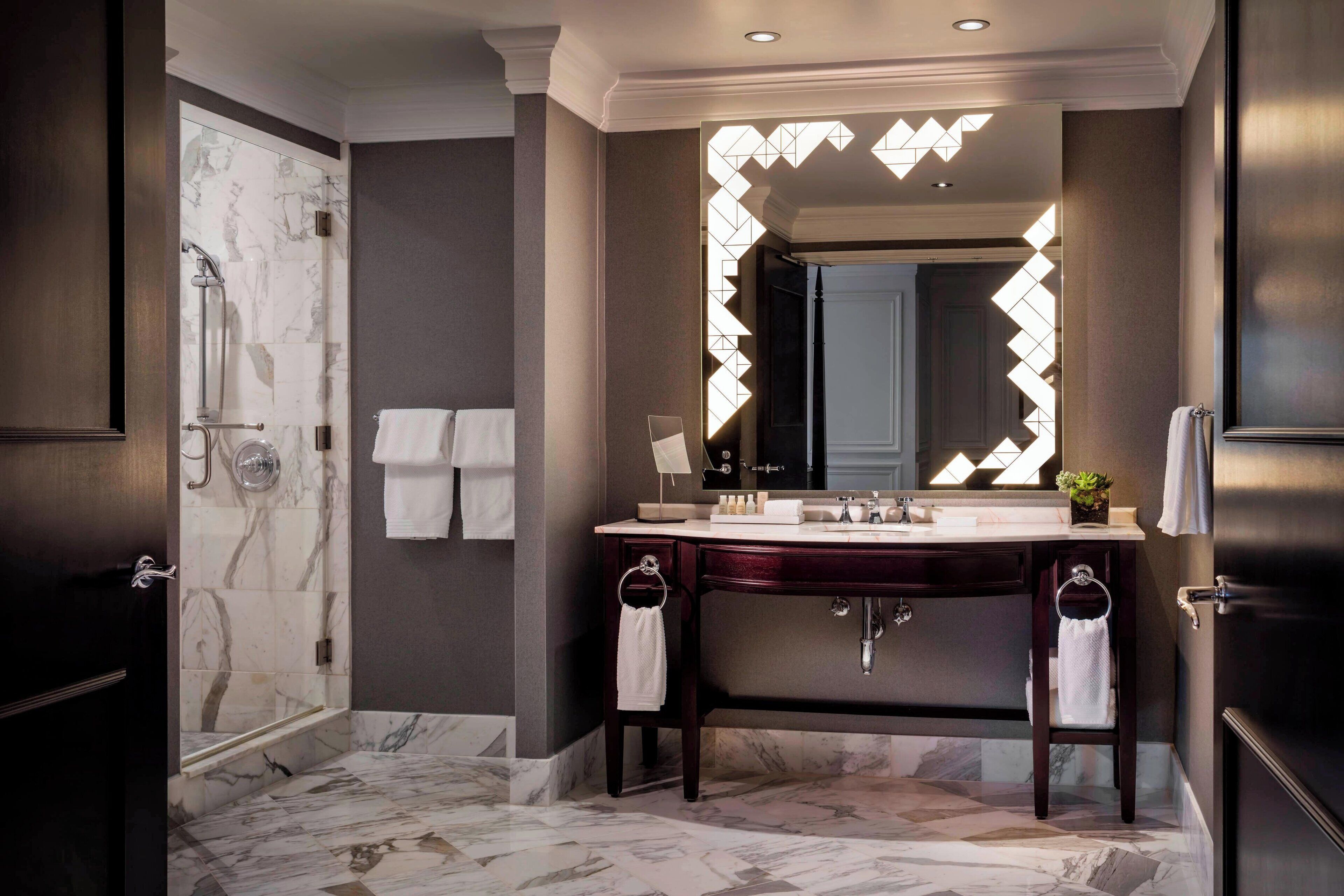 combined shower/bathtub, designer toiletries, hair dryer, towels