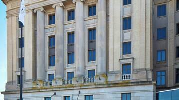 A Renaissance hotel with a classical facade, large columns, and a prominent 'R' on the top.