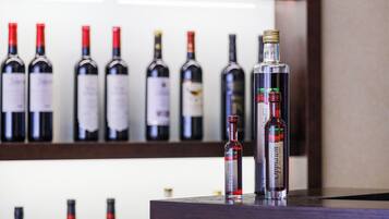 A selection of wine bottles on a shelf.